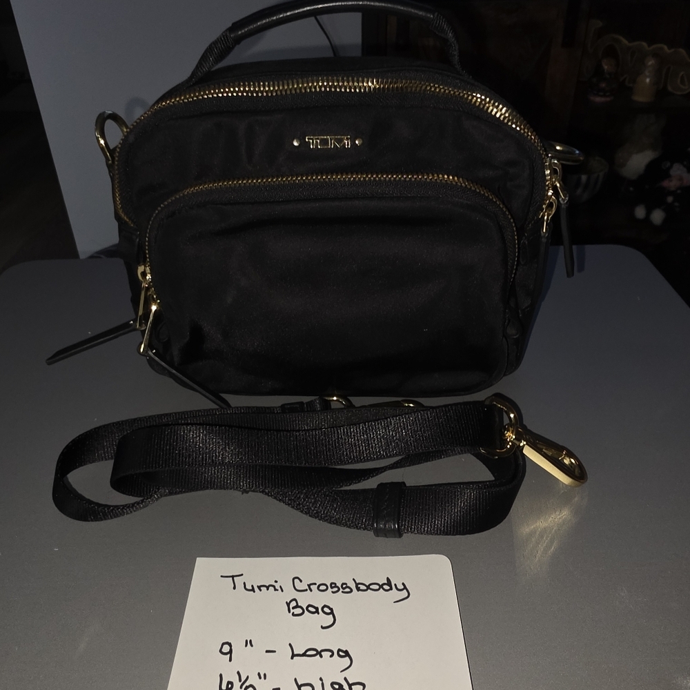 Tumi brand black purse.